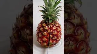 Miniature : Ruby quartz shaped like a pineapple being sliced with a sharp knife
